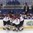 POPRAD, SLOVAKIA - APRIL 14: Latvia's Valters Egle #9, Rihards Paskausks #25, Sandis Smons #7, and Renars Karkls #3 gather around head coach Igors Smirnovs as he draws up a play during a time out during preliminary round action against Switzerland at the 2017 IIHF Ice Hockey U18 World Championship. (Photo by Andrea Cardin/HHOF-IIHF Images)

